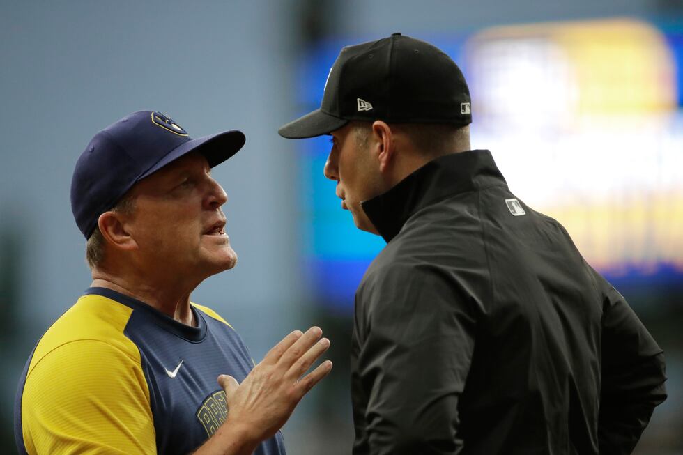 Milwaukee Brewers' bench coach Pat Murphy, left, talks with umpire John Libka during the sixth...