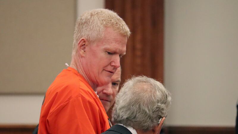 Convicted murderer Alex Murdaugh speaks with his defense attorney, Dick Harpootlian, in...
