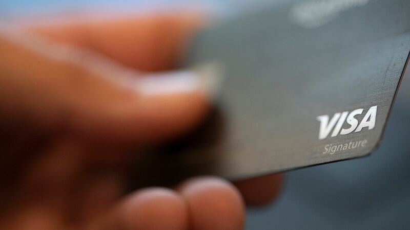 FILE - This Aug. 11, 2019, file photo shows a Visa logo on a credit card in New Orleans.