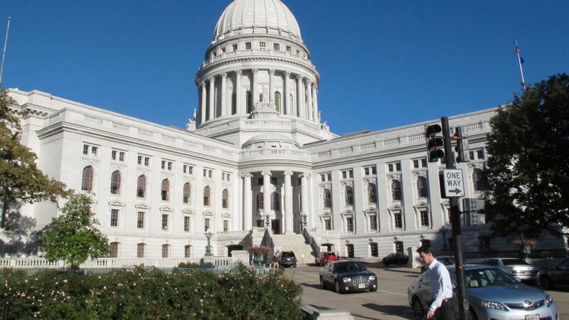 A man walks by the Wisconsin state Capitol, Oct. 10, 2012, in Madison, Wis. (AP Photo/Scott...