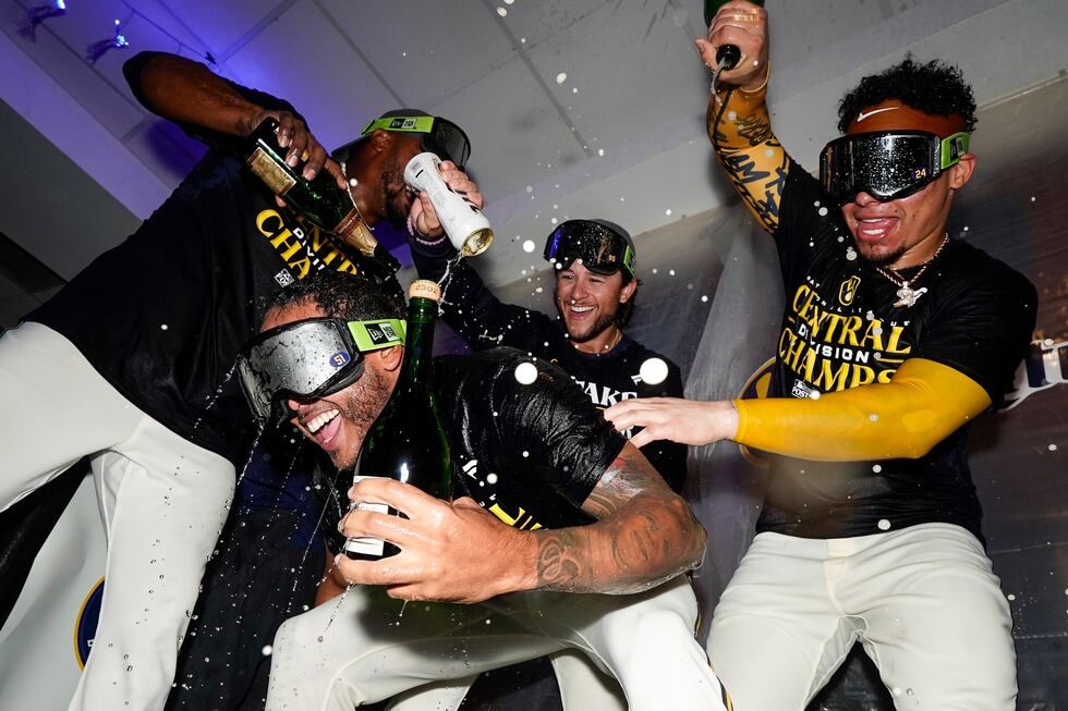 Milwaukee Brewers' Freddy Peralta is doused as the Brewers celebrate after clinching the NL...