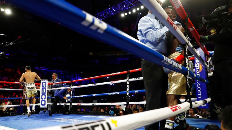 Teofimo Lopez, left, reacts after defeating Ghana's Richard Commey by TKO during the second...