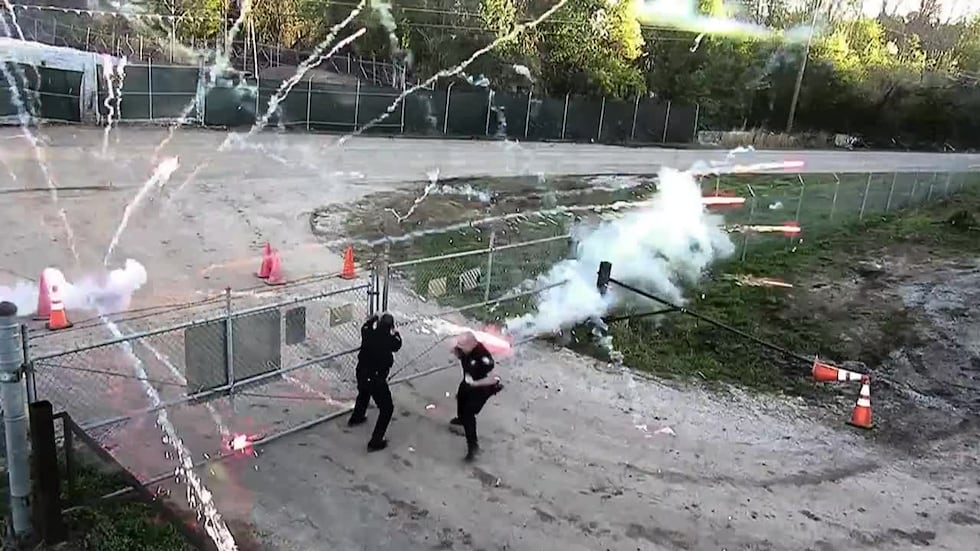 Fireworks are thrown at officers Sunday at 'Cop City,' a controversial future public training...