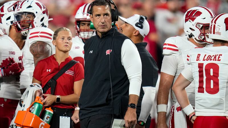 Wisconsin head coach Luke Fickell checks the scoreboard during the first half of an NCAA...