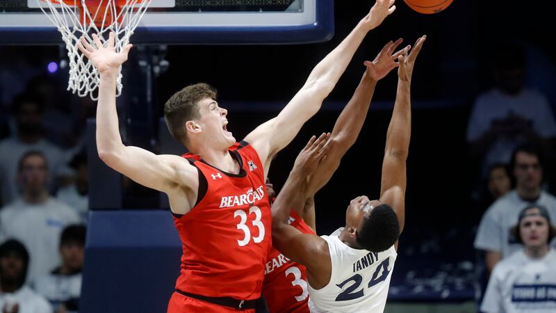 FILE - In this Dec. 7, 2019, file photo, Cincinnati's Chris Vogt (33) blocks a shot by...