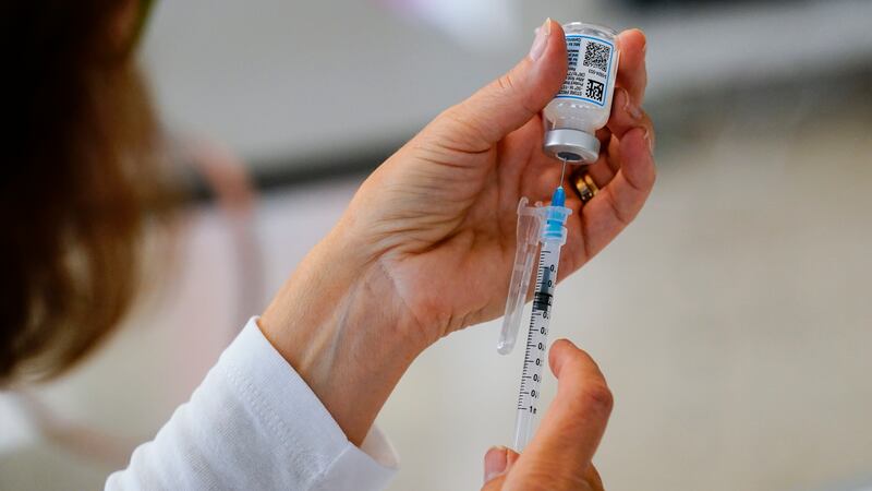 FILE - A syringe is prepared with the Moderna COVID-19 vaccine at a clinic in the Norristown...