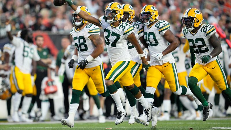 Green Bay Packers cornerback Carrington Valentine (37) celebrates after intercepting a pass...