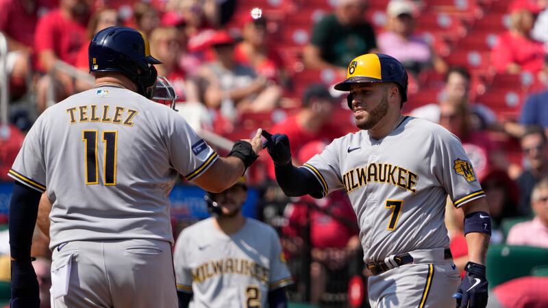 Milwaukee Brewers' Victor Caratini (7) is congratulated by teammate Rowdy Tellez (11) after...