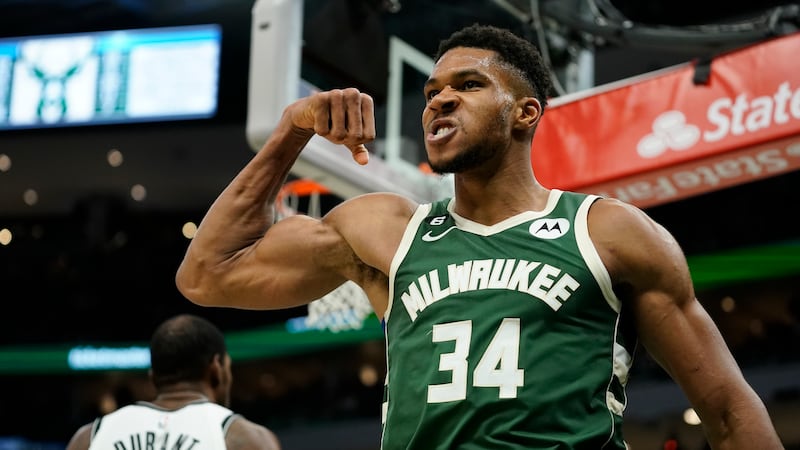 Milwaukee Bucks' Giannis Antetokounmpo reacts after making a shot and being fouled during the...