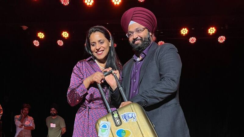 The co-founders of Child Health Imprints holding the golden briefcase, the trophy of the...