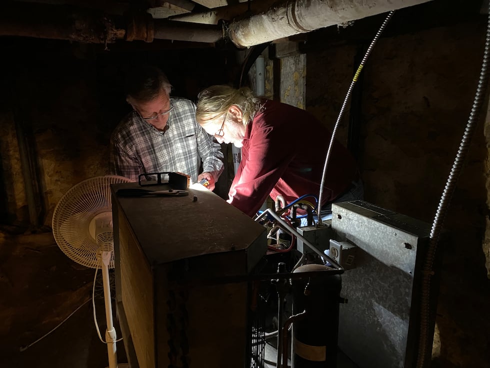Refrigeration consultant Kevin Macke (left) and steamfitter Jim Gryzynger (right) work on the...