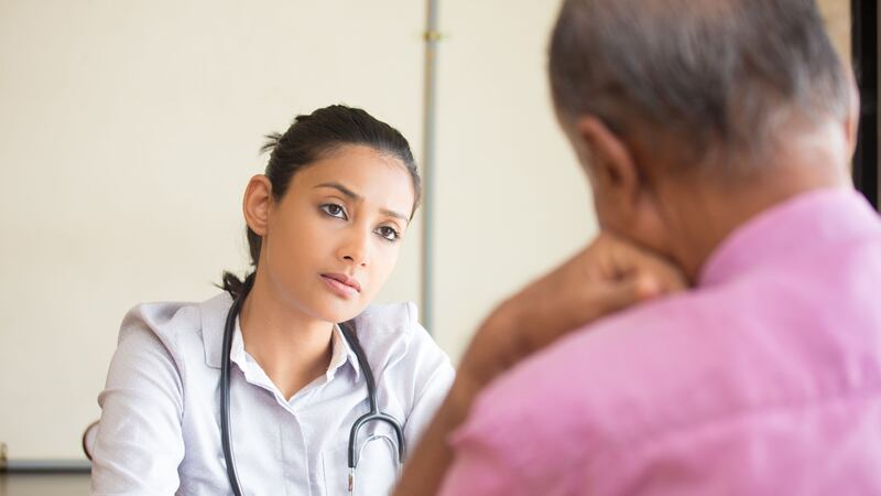 Closeup portrait, patient talking serious conversation to healthcare professional, isolated...