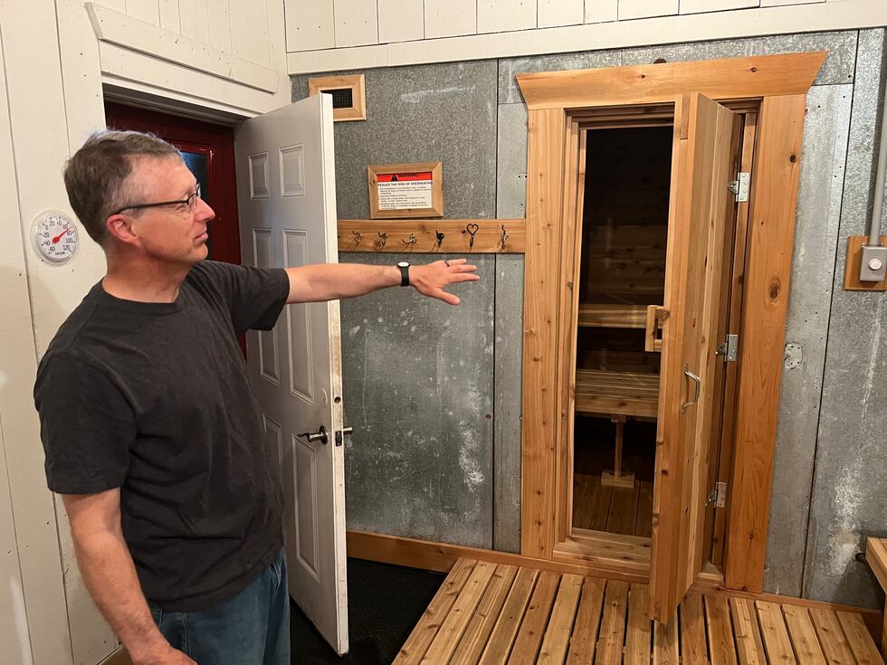 Shannon Marion shows off the sauna he built for guests inside his barn