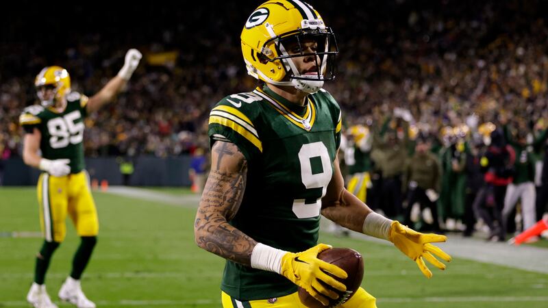 Green Bay Packers wide receiver Christian Watson (9) celebrates catching a touchdown pass...