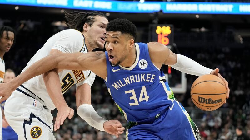 Milwaukee Bucks' Giannis Antetokounmpo is fouled by Denver Nuggets' Aaron Gordon during the...