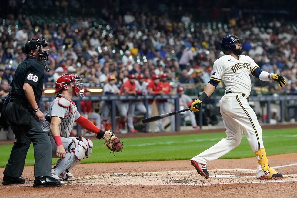 Milwaukee Brewers' Carlos Santana hits and RBI double during the third inning of a baseball...