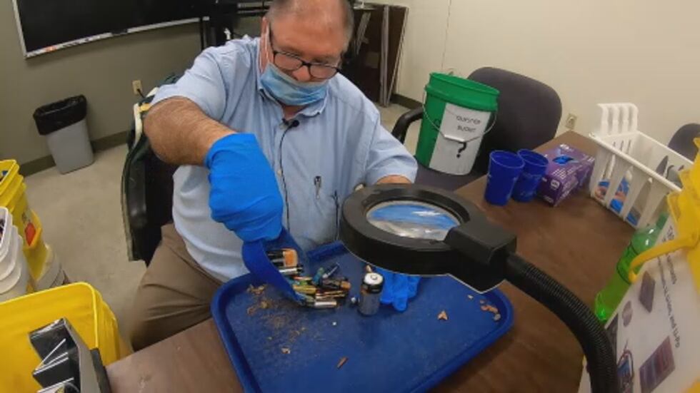 One man works to sort recycled batteries by hand.