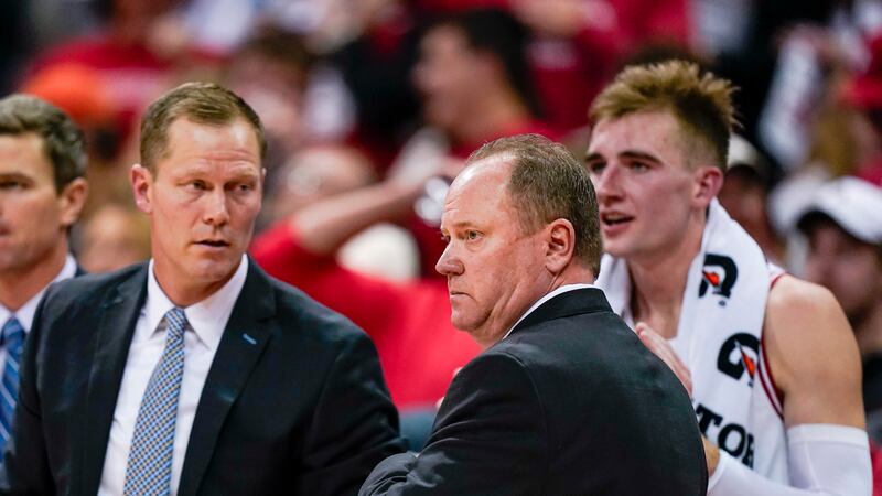 Wisconsin coach Greg Gard, right front, stands with associate head coach Joe Krabbenhoft,...